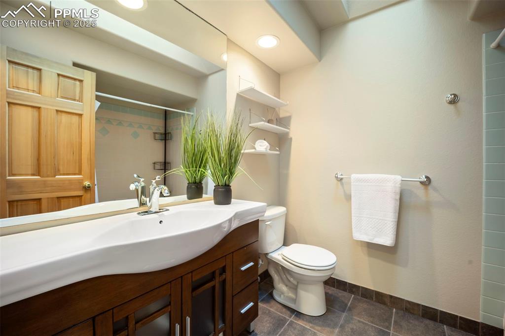 Image 13 of 33: Bathroom with vanity and a tile shower
