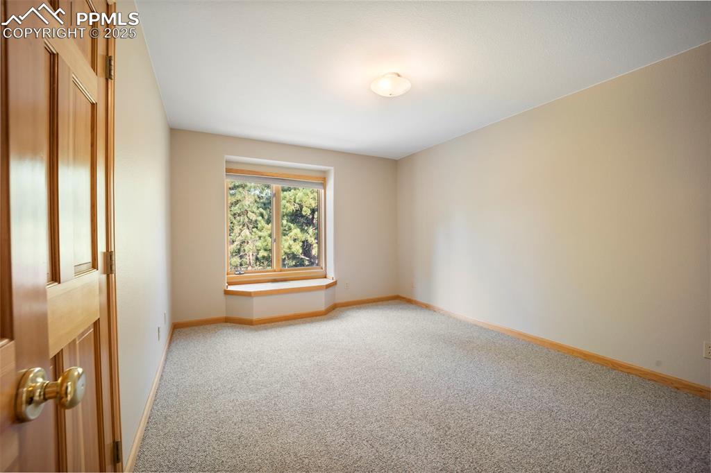 Image 14 of 33: Carpeted empty room with baseboards