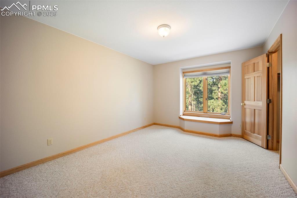 Image 15 of 33: Carpeted empty room with baseboards