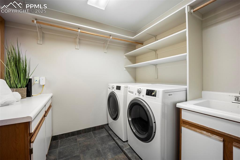 Image 19 of 33: Laundry room with cabinet space and separate washer and dryer