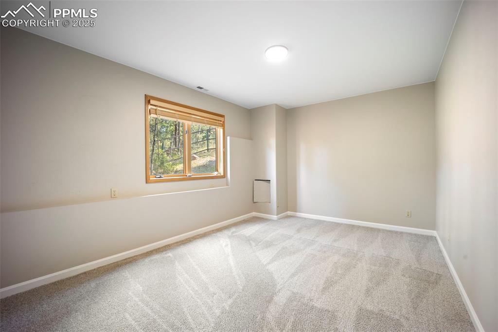 Image 21 of 33: Carpeted empty room featuring baseboards