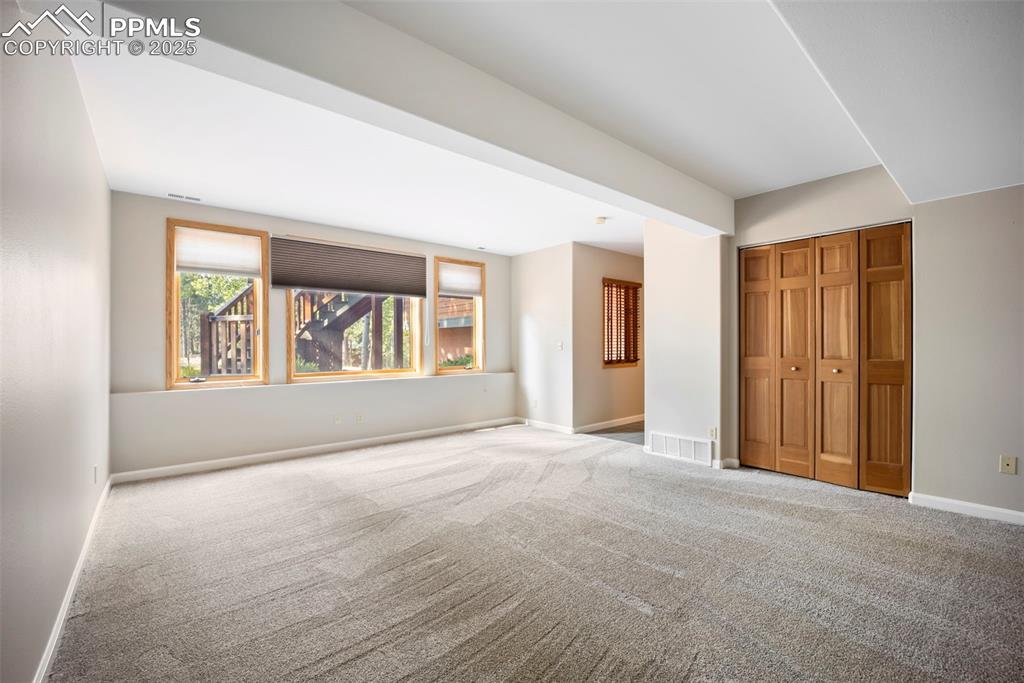 Image 22 of 33: Unfurnished bedroom with carpet floors and a closet