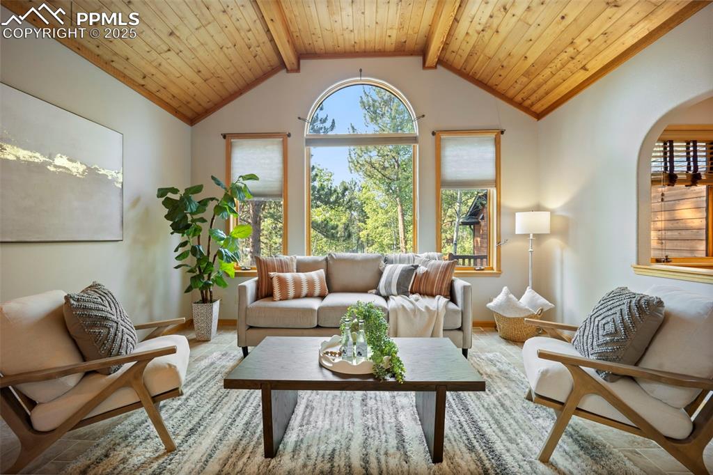 Image 3 of 33: Sitting room with wooden ceiling and baseboards