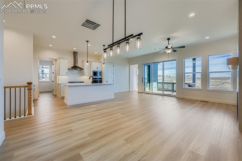 Image 10 of 28: Unfurnished living room featuring recessed lighting, light wood finished fl