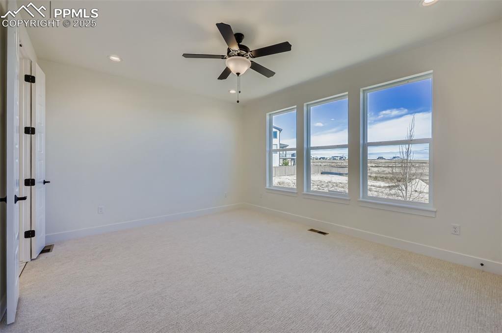 Image 11 of 28: Empty room featuring light carpet, recessed lighting, and ceiling fan