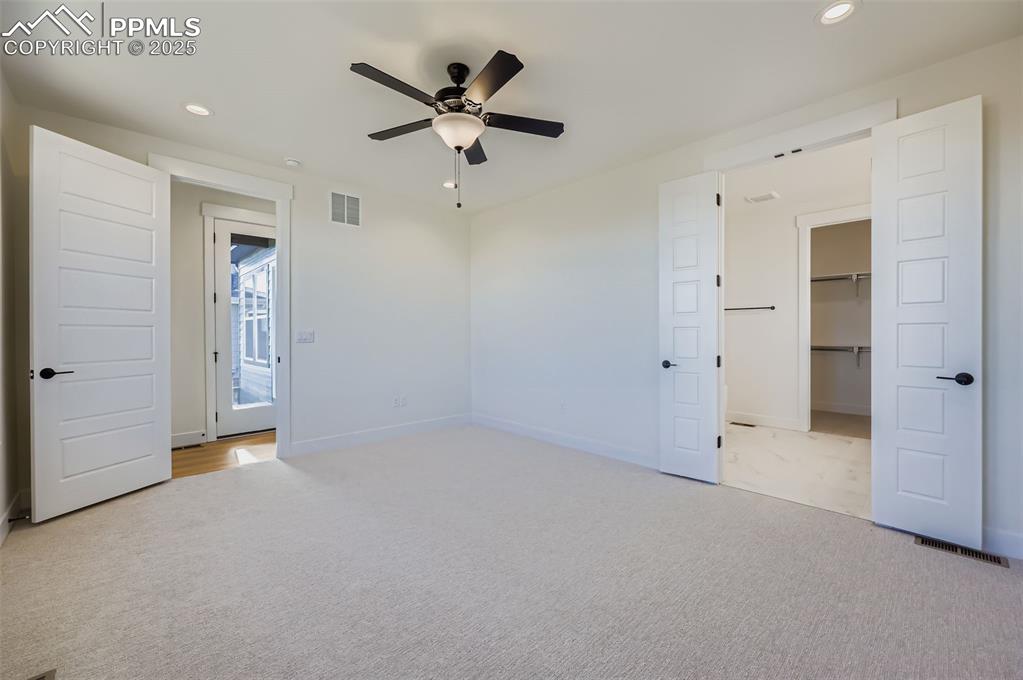 Image 12 of 28: Unfurnished bedroom featuring recessed lighting, a walk in closet, a ceilin