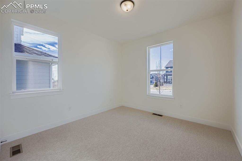 Image 15 of 28: Unfurnished room with baseboards and carpet floors