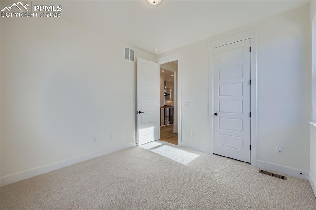 Image 16 of 28: Unfurnished bedroom featuring carpet and a closet