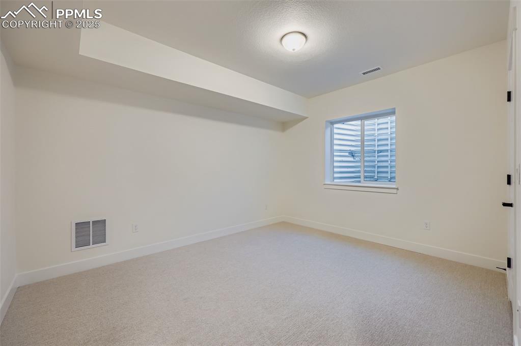 Image 20 of 28: Unfurnished room featuring baseboards and light colored carpet