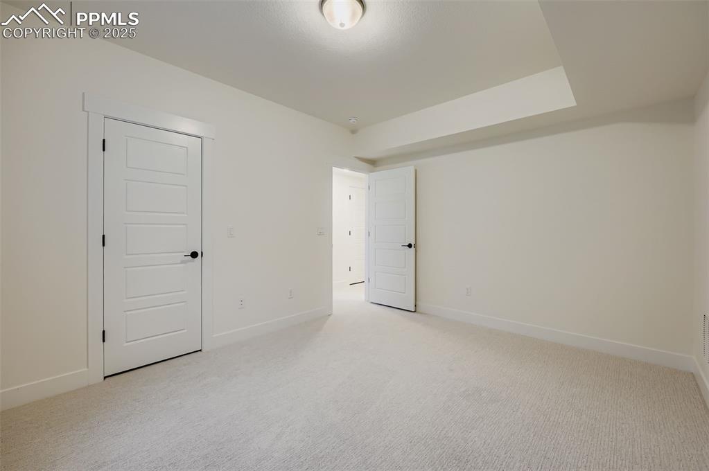 Image 21 of 28: Unfurnished bedroom with light carpet and baseboards