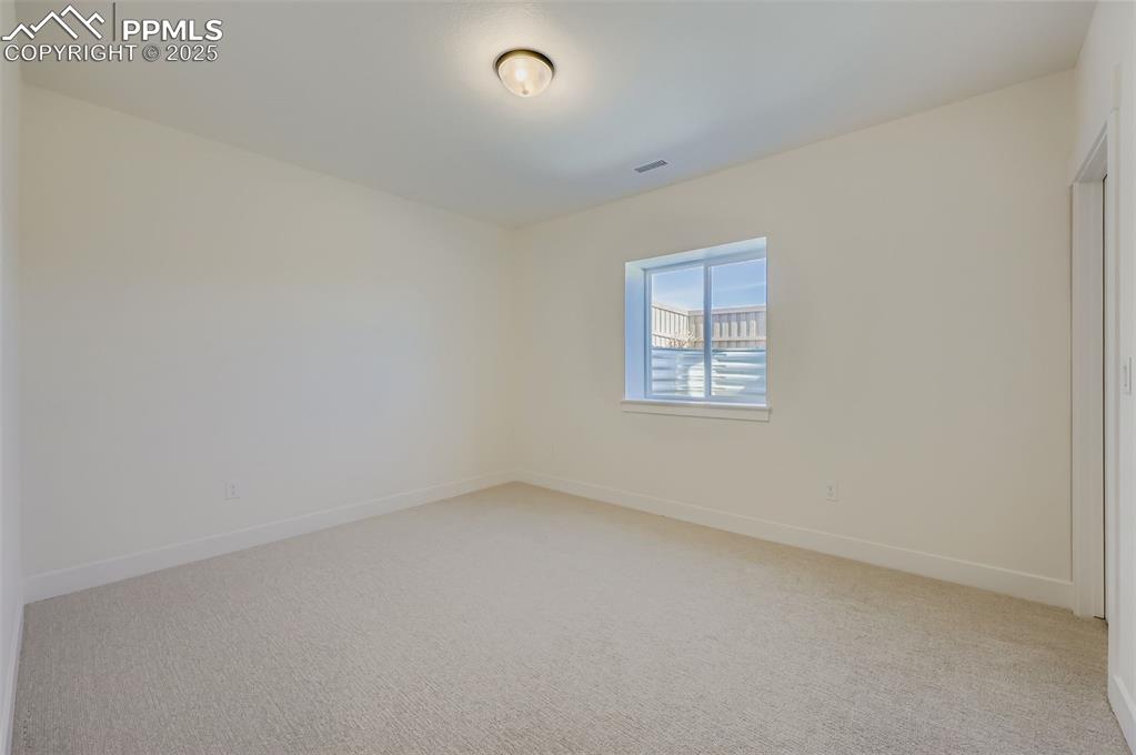 Image 22 of 28: Empty room featuring light colored carpet and baseboards