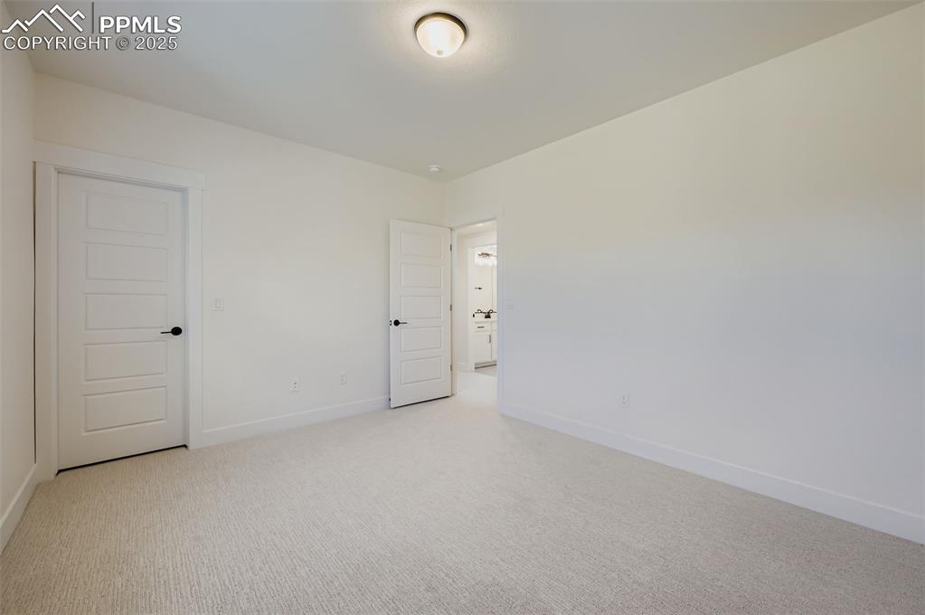 Image 23 of 28: Spare room with light colored carpet and baseboards