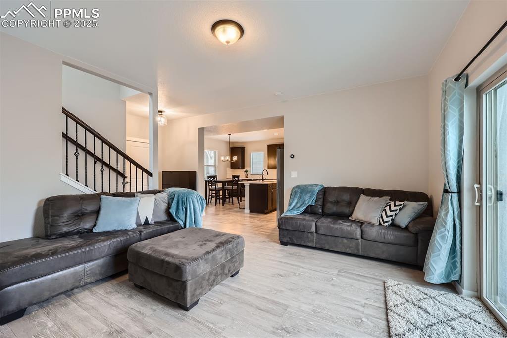 Image 10 of 46: LVP through main level. Family room, with walkout to patio and fenced backy