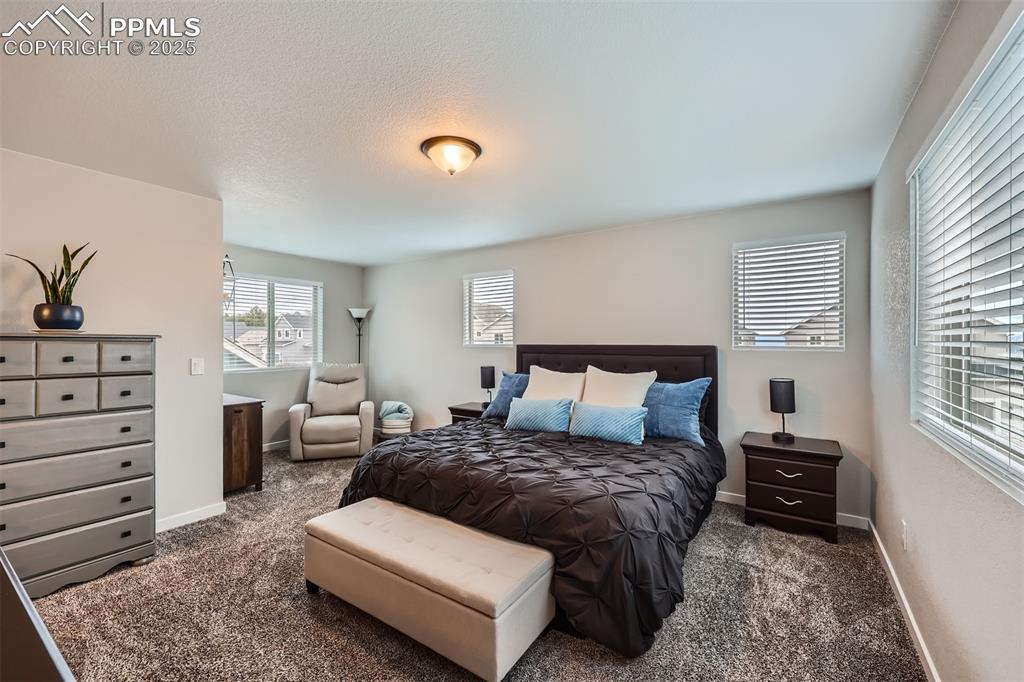 Image 16 of 46: Primary suite with sitting area.