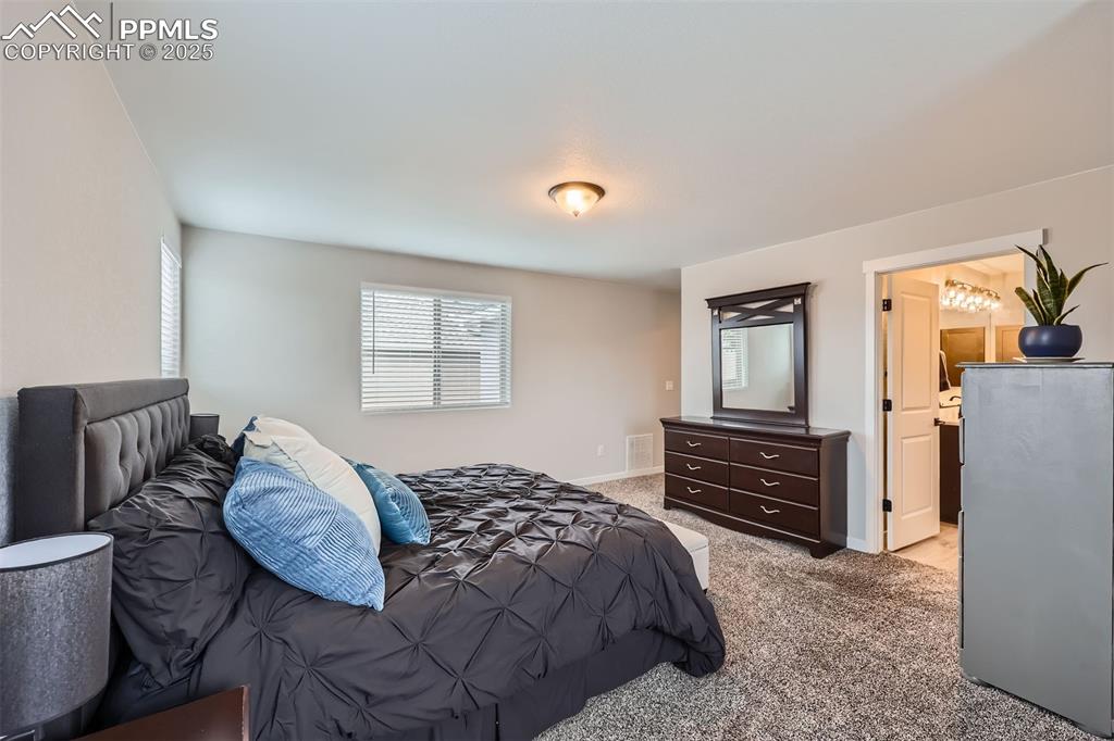Image 17 of 46: Primary suite with sitting area.