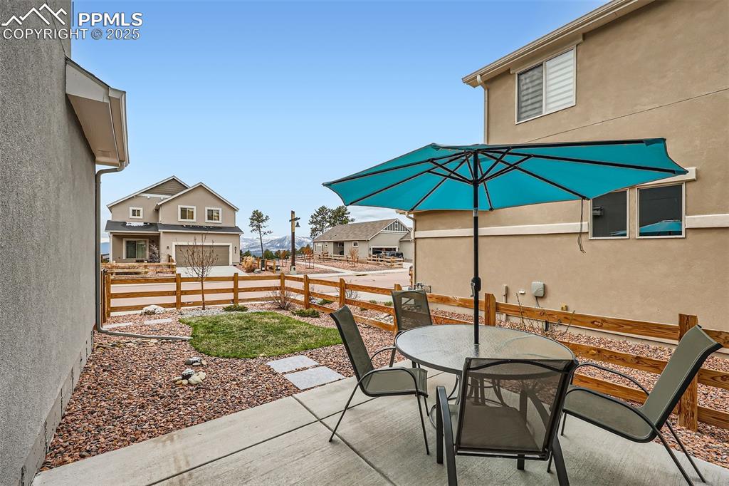 Image 28 of 46: Fenced backyard, concrete patio, mountain views.
