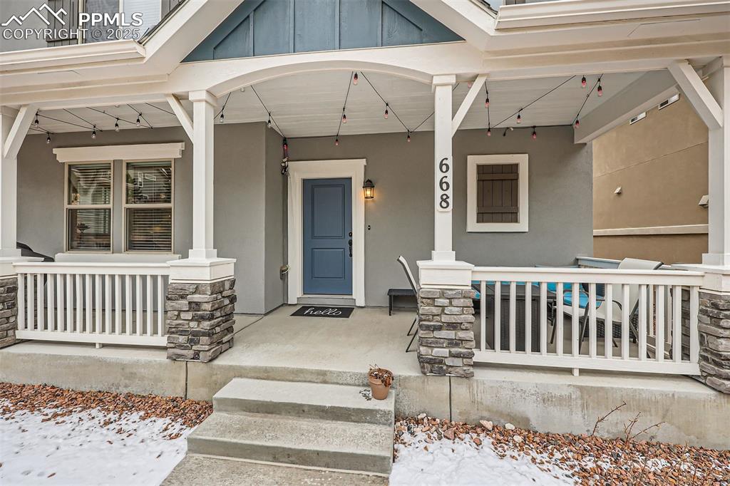 Image 6 of 46: Covered front porch and space for sitting and grilling.