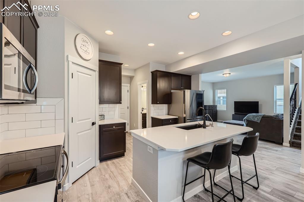 Image 7 of 46: Stainless steel appliances, quartz countertops, pantry, island, gourmet kit