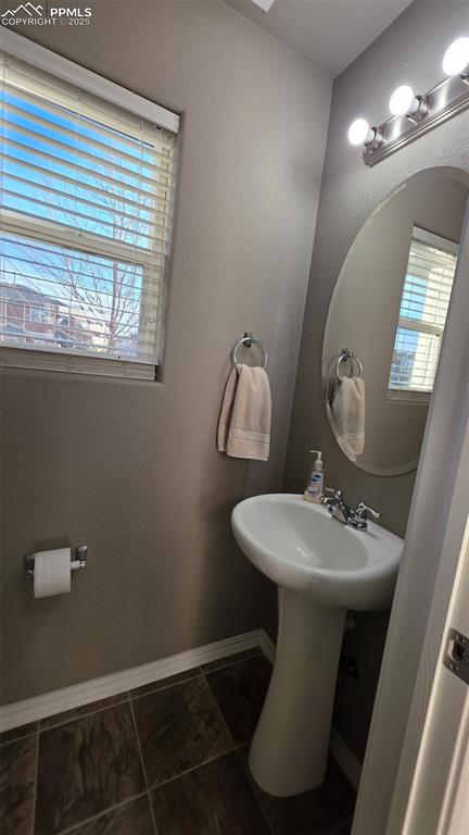 Image 4 of 8: Half bath featuring a textured wall and baseboards