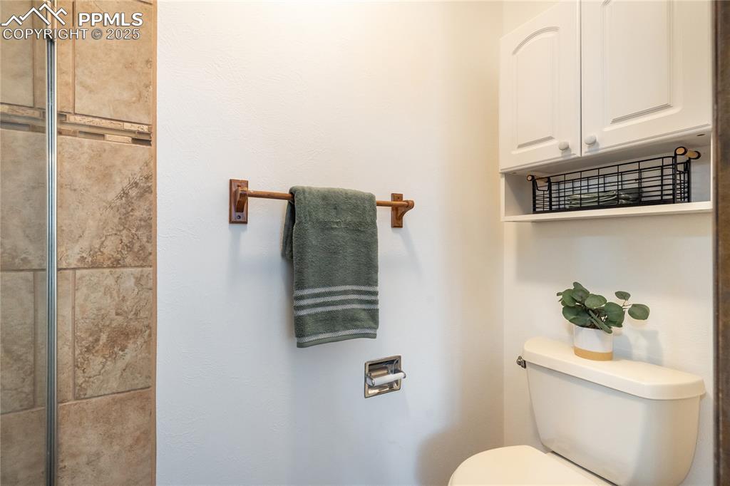 Image 28 of 50: Private shower & commode space to primary bedroom