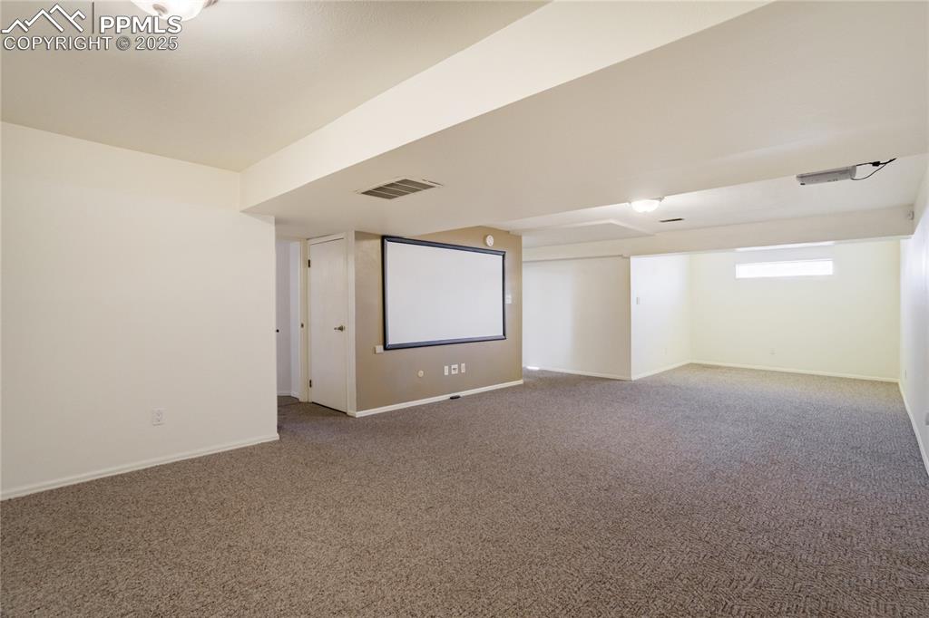 Image 36 of 50: Basement Family Room includes Projector and Screen