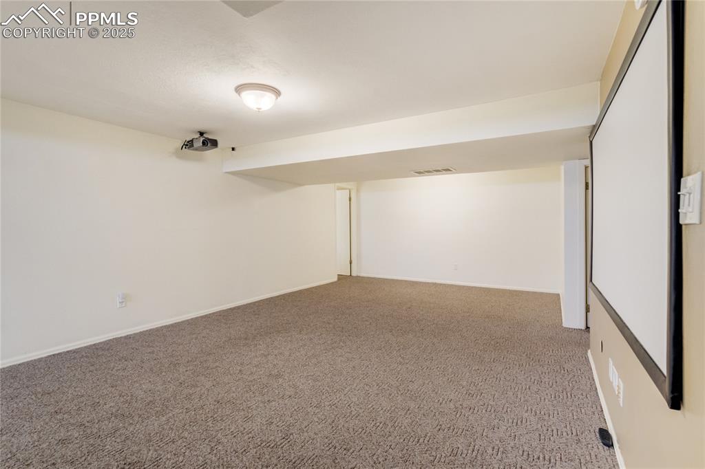 Image 37 of 50: Finished below grade area with light colored carpet and baseboards