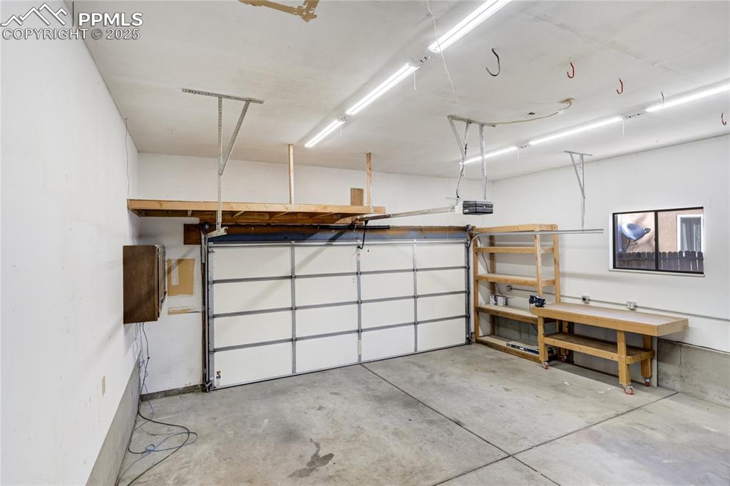 Image 43 of 50: Over-sized 2 car garage finished with insulated garage door and garage door