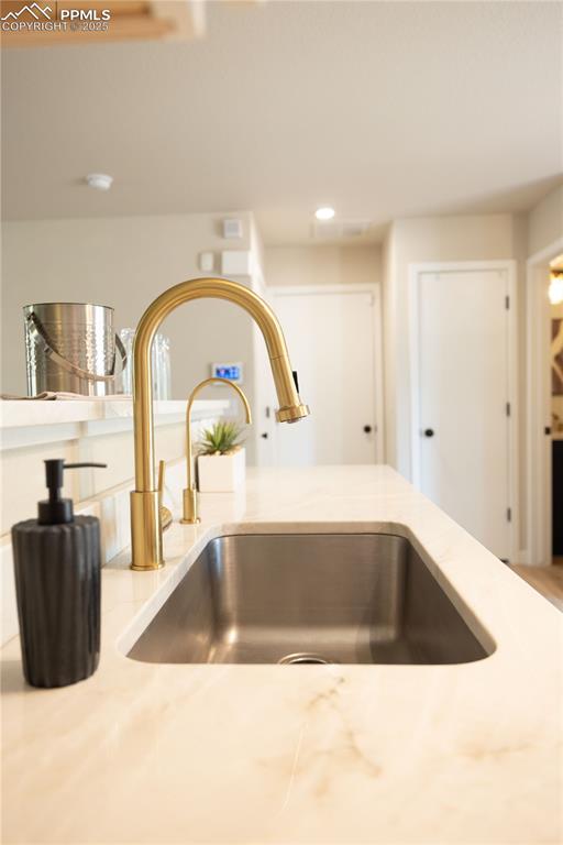 Image 11 of 42: Kitchen view of a sink and recessed lighting