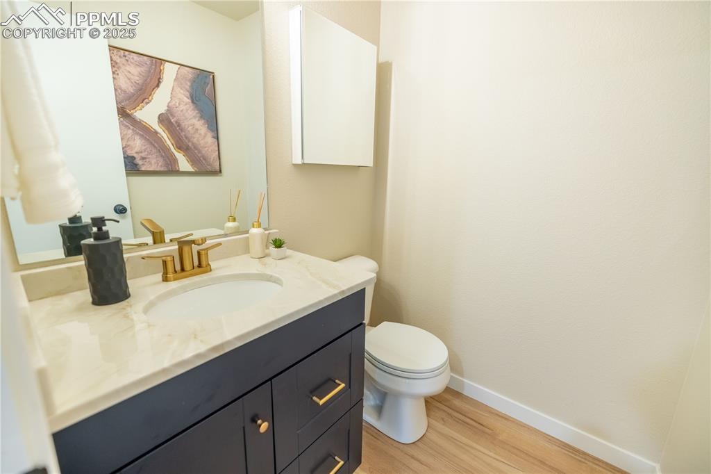 Image 16 of 42: Bathroom with wood finished floors and vanity