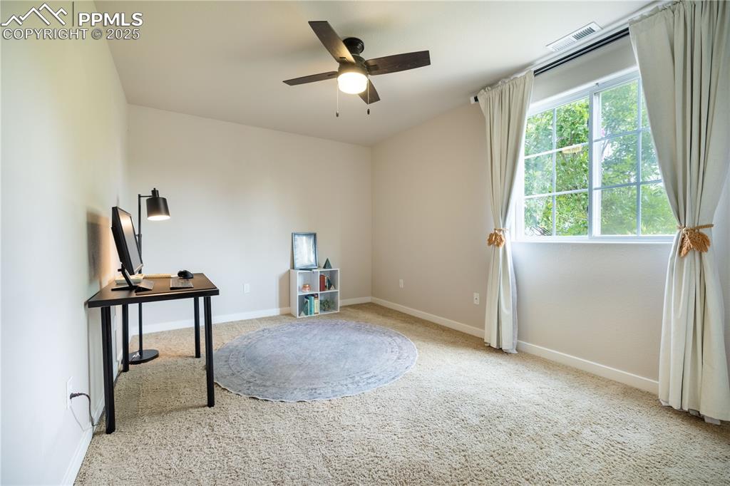Image 19 of 42: Misc room featuring carpet, a ceiling fan, and an office area