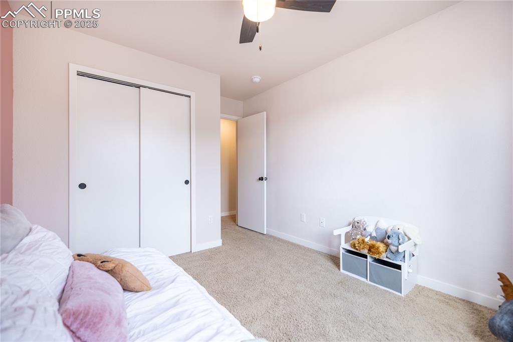 Image 29 of 42: Bedroom with carpet flooring, a closet, and a ceiling fan
