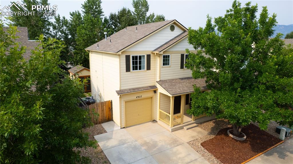 Image 39 of 42: View of front of property with roof with shingles, an attached garage, driv
