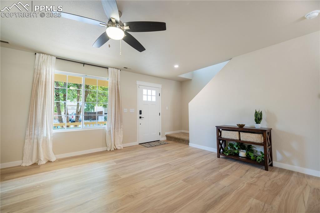 Image 6 of 42: Entryway featuring ceiling fan and light wood finished floors
