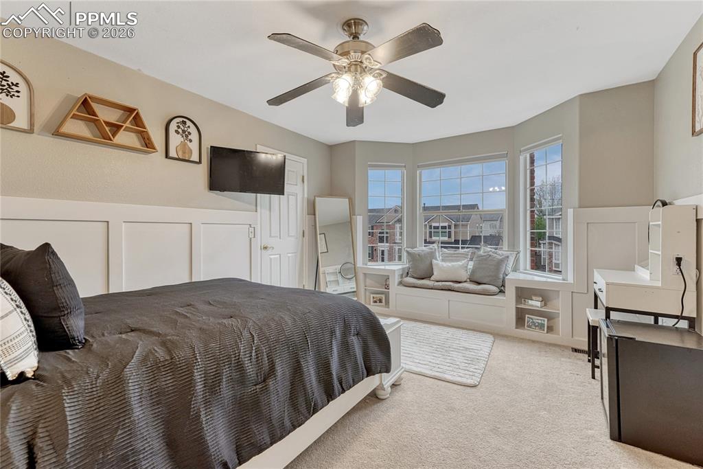 Image 36 of 48: This bedroom has built-in window seating w/ storage.