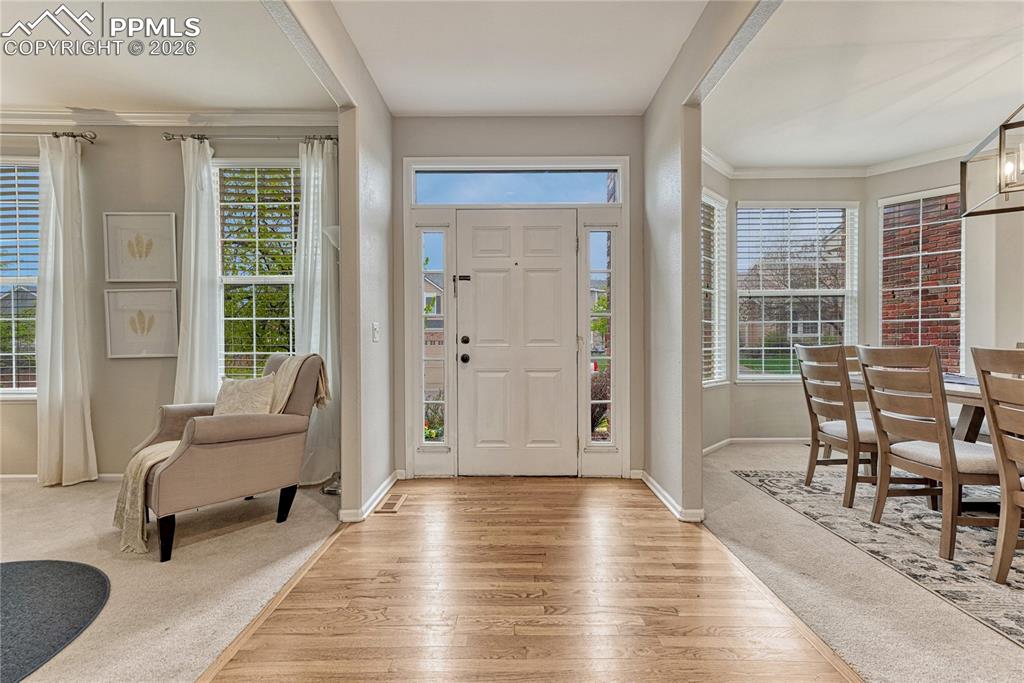 Image 4 of 48: Wood floor entry flanked by formal rooms