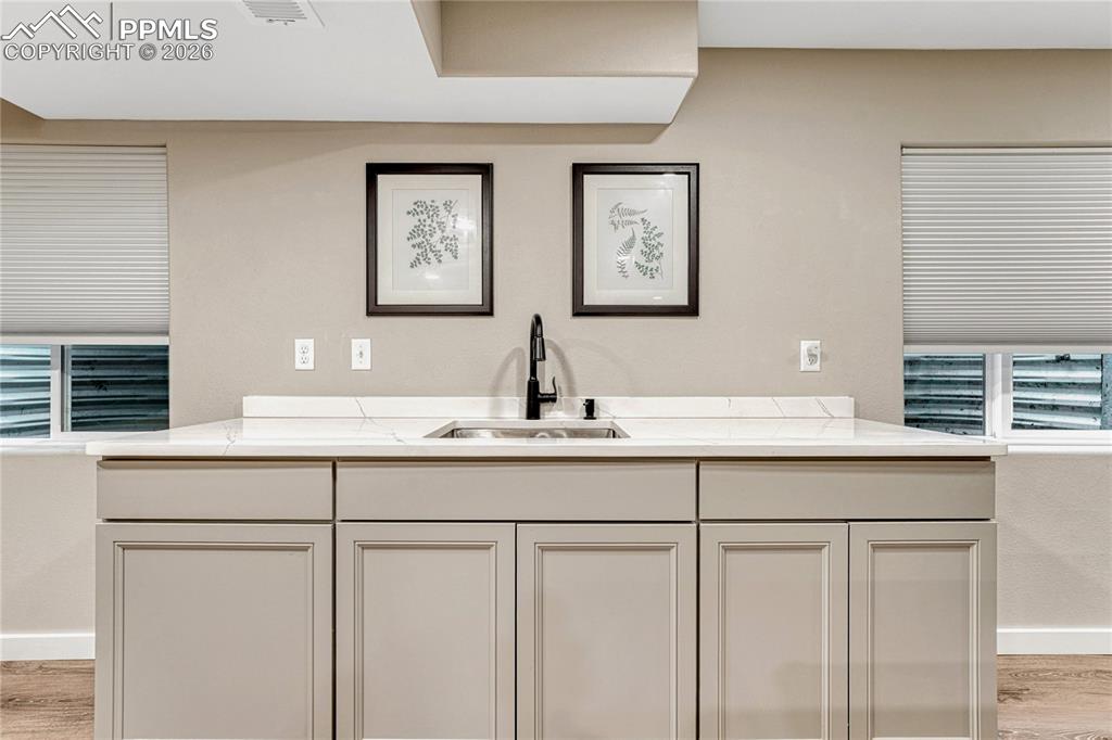 Image 41 of 48: Wet bar with plenty of counter space and storage.