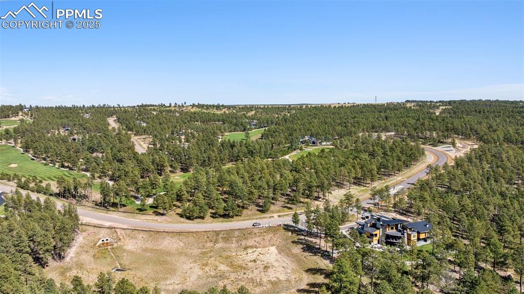 Image 8 of 14: 2024 Parade Home on Adjacent Lot and detention pond, no home here. Preserve