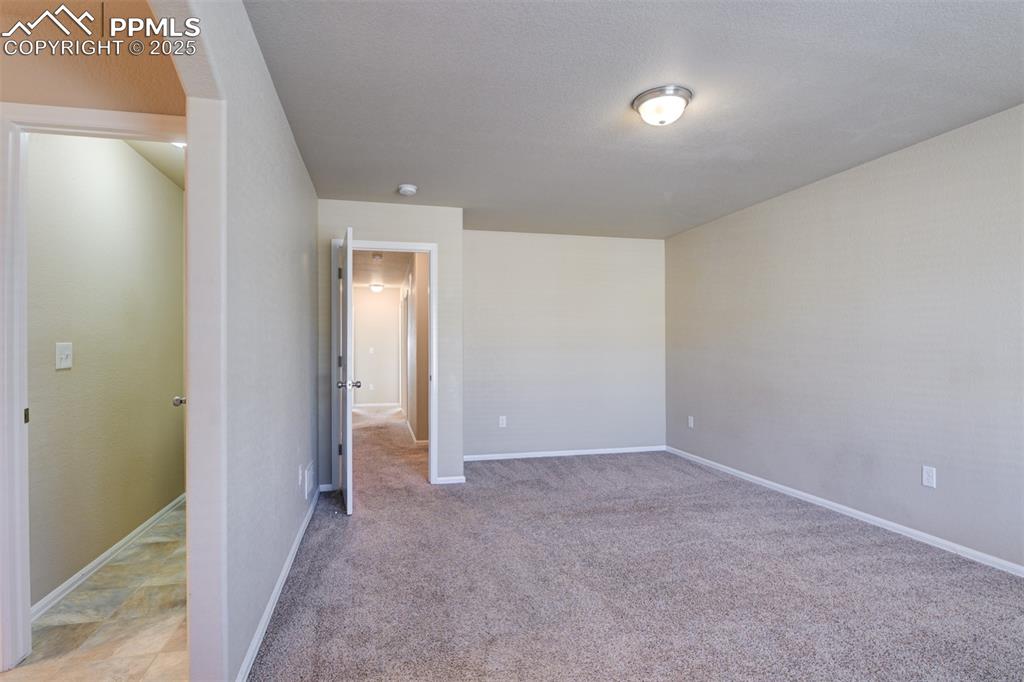 Image 21 of 33: Unfurnished bedroom with baseboards and light colored carpet