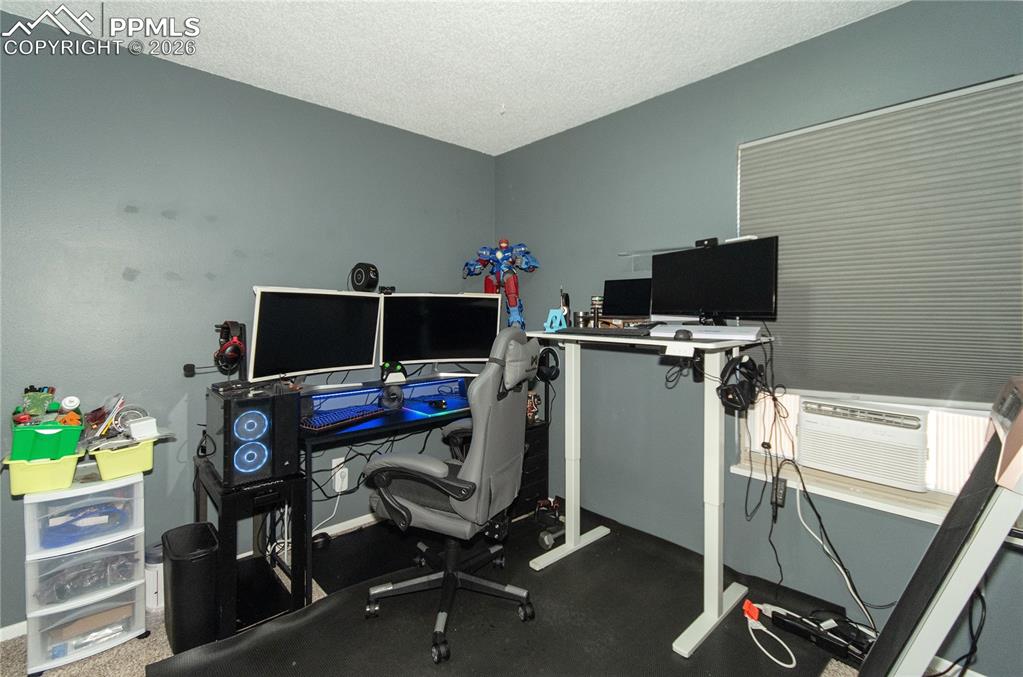 Image 16 of 24: Third bedroom currently used as home office.