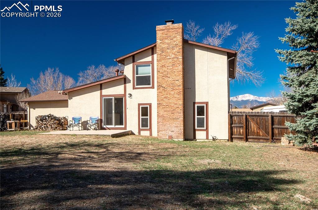 Image 20 of 24: Back of house with Pikes Peak view