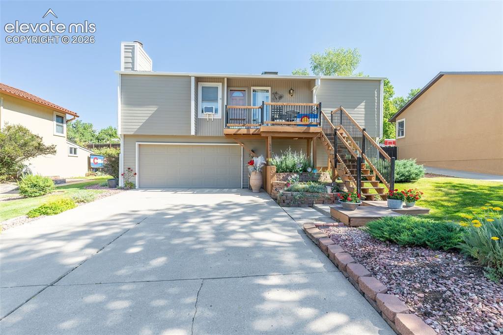 Image 1 of 24: Split-level residence featuring attached two-car garage, and an upper-level