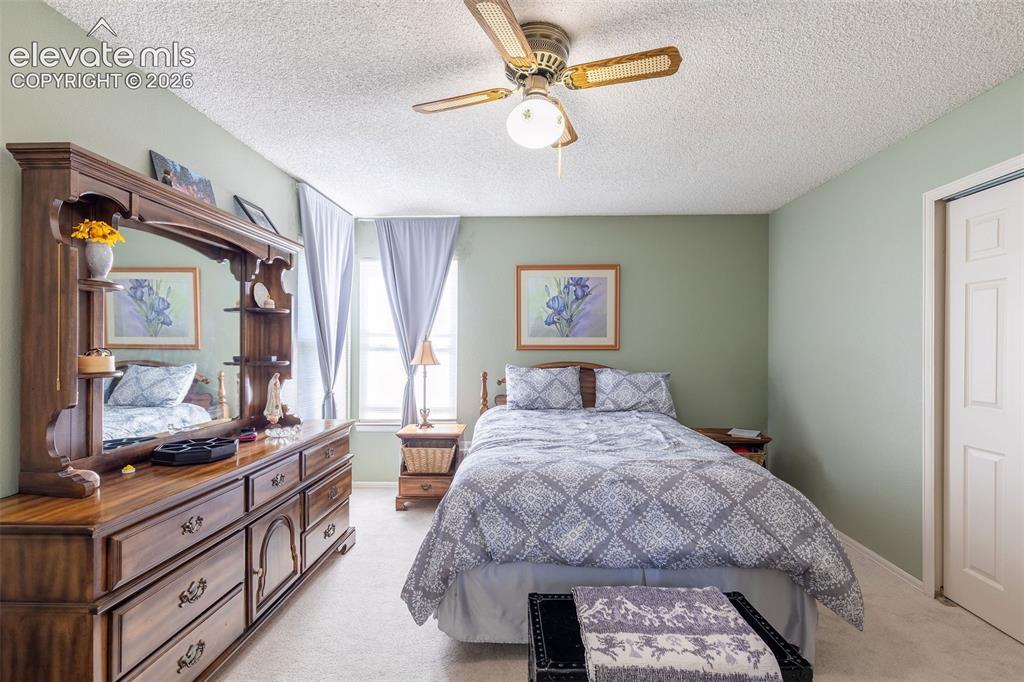 Image 13 of 24: Carpeted interior space featuring a ceiling fan with integrated lighting, w