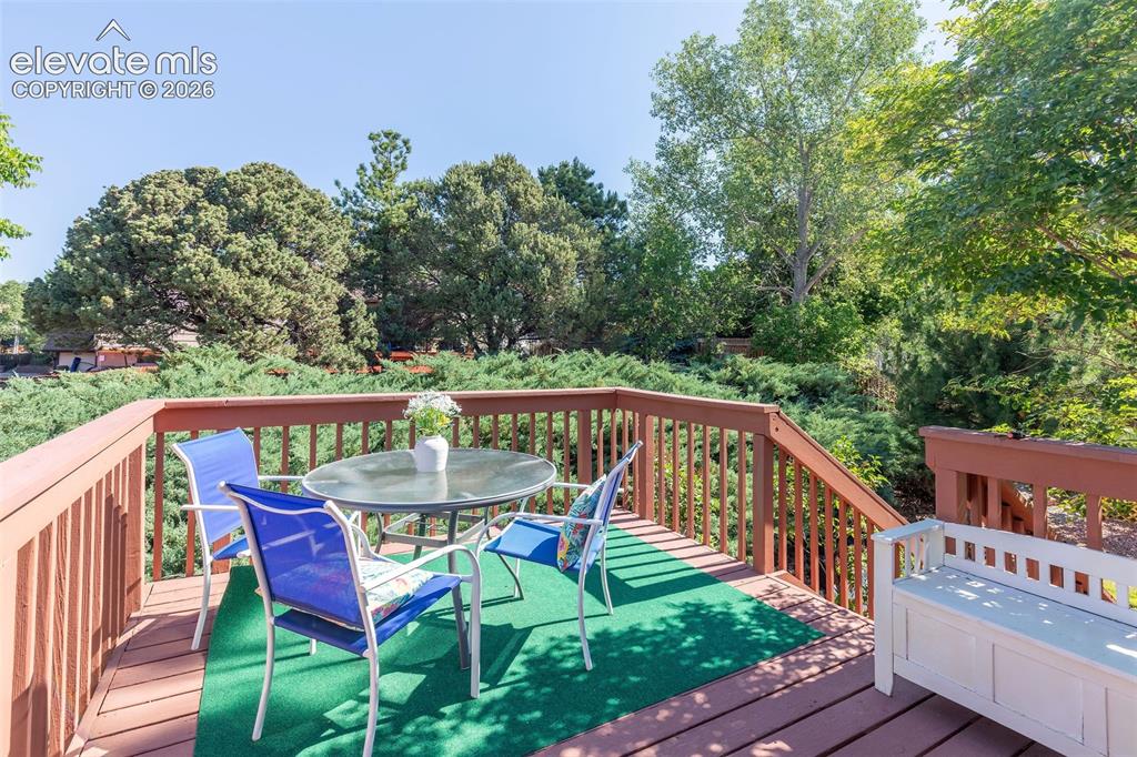 Image 19 of 24: Spacious exterior deck featuring wood-finish railing and steps, ample room