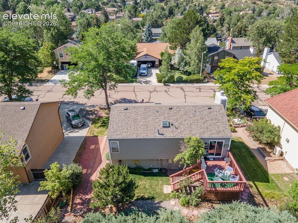Image 22 of 24: Rear exterior featuring a multi-level wood deck, sliding glass door access,