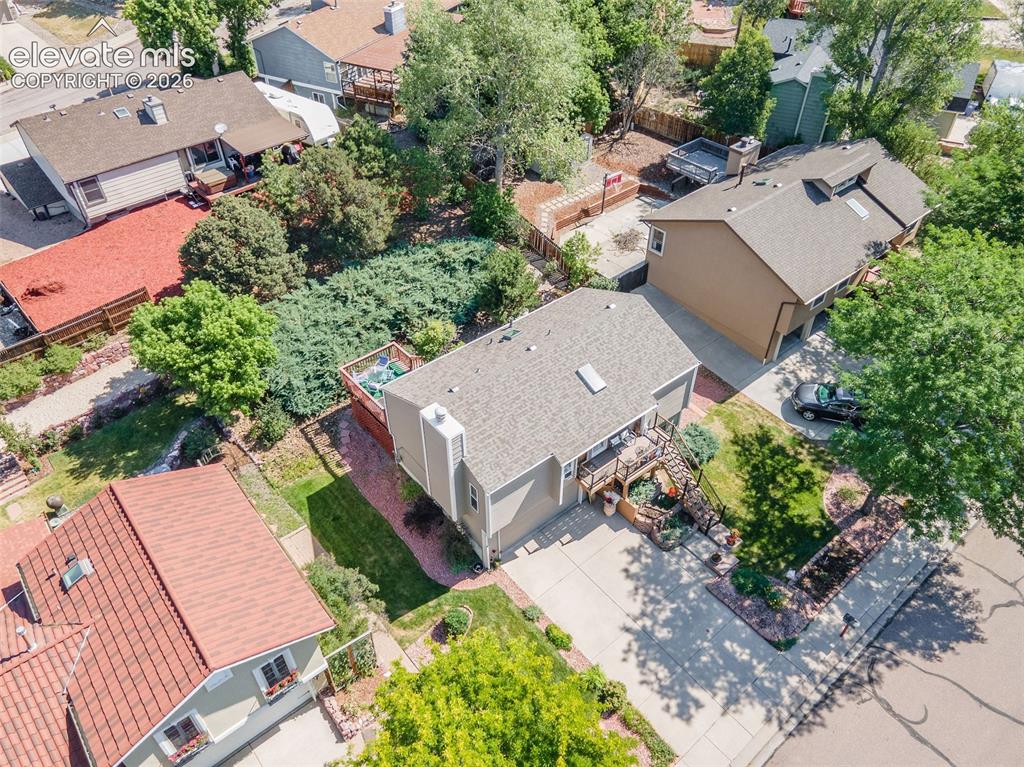 Image 23 of 24: Expansive property with a tan exterior, a neutral-toned roof, and a multi-l
