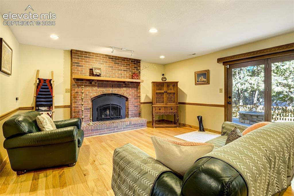 Image 31 of 50: Lower level family room with gas firplace