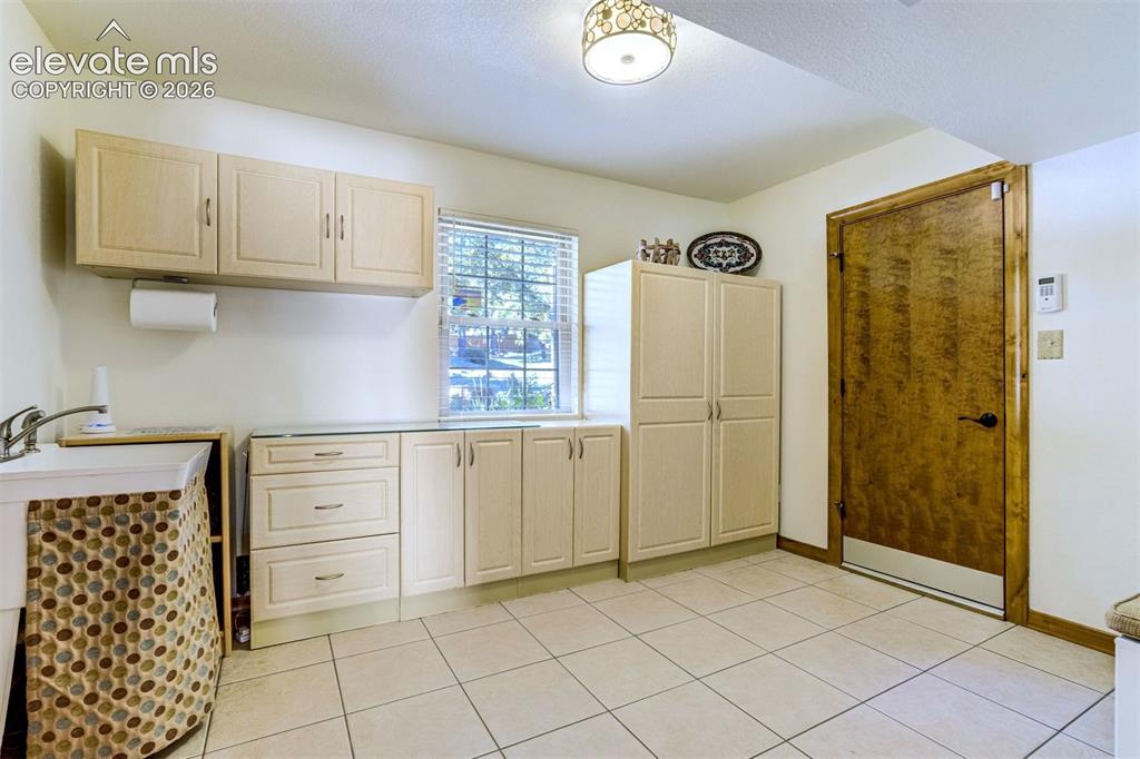 Image 35 of 50: Large mudroom off of the garage