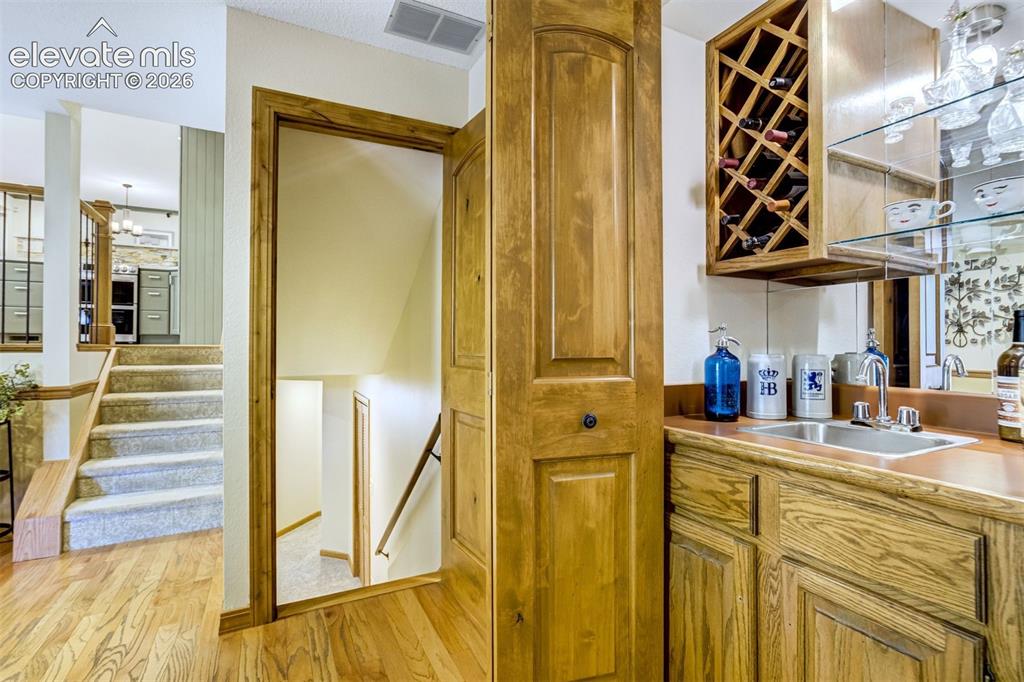 Image 36 of 50: Wet bar in lower level family room