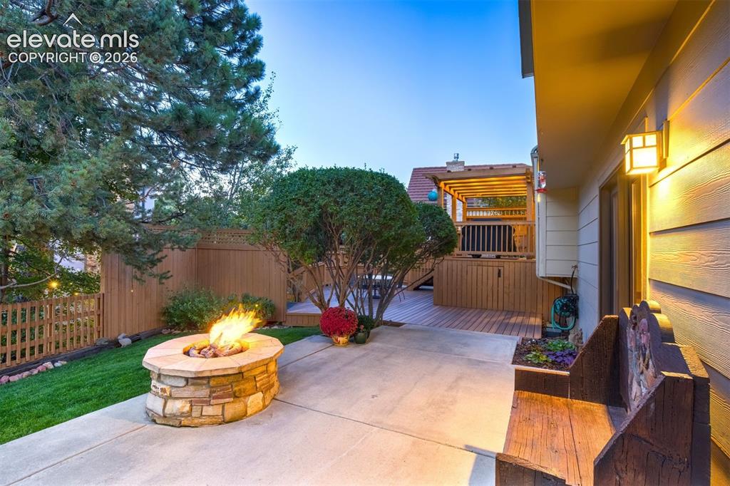 Image 43 of 50: Step into a beautifully landscaped private oasis, where mature trees, vibra