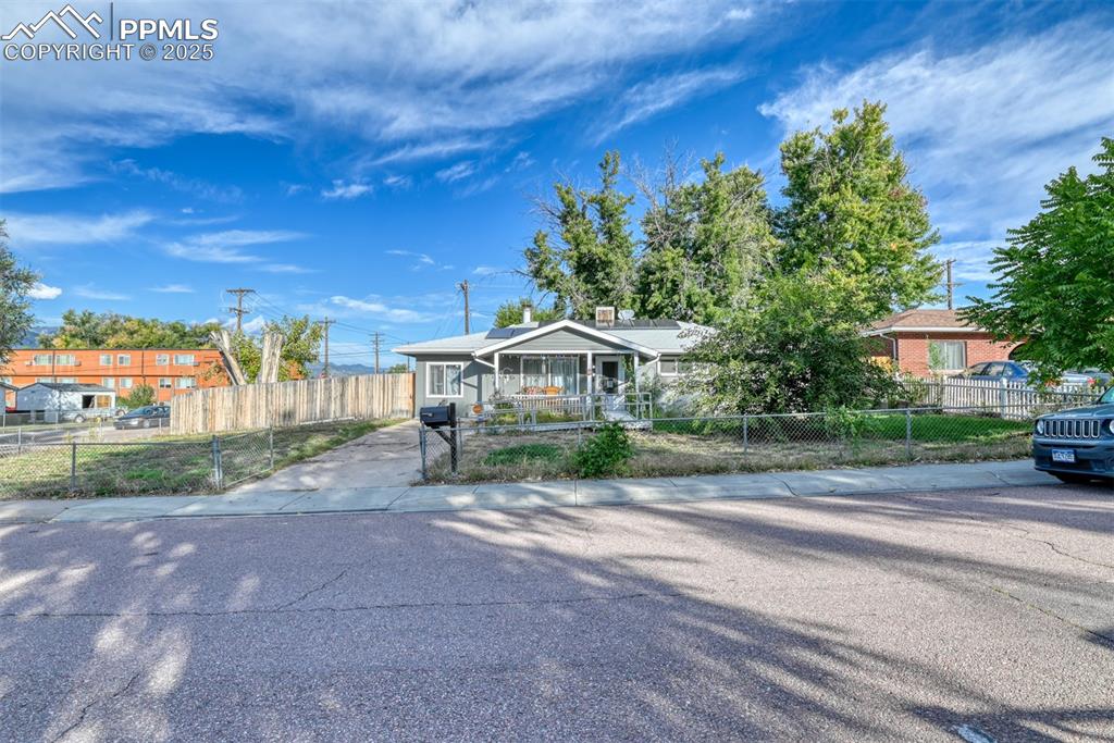 Caption: View of front facade featuring a fenced front yard